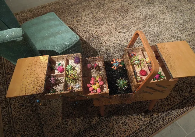 Miasma III: Pestilence and Providence: sewing cart with covid sculptures and beaded miasma net