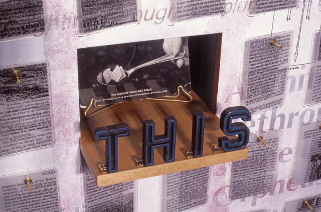 Speaking Volumes: This Will Kill That: detail: “THIS” panel with postcard of world’s smallest Bible and “THAT” in tiny gold block letters