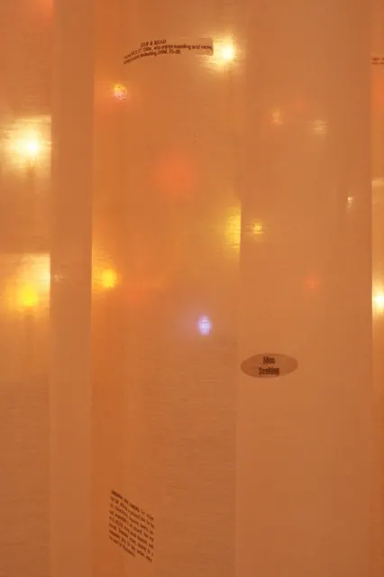 Surveying Desire VIII: Reconnaissance: detail: curtain with personal ads and electric candles behind