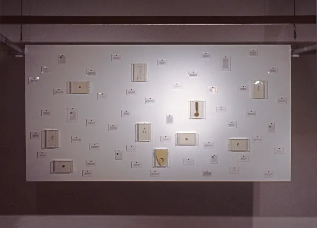 Surveying Desire XII: Fictions: suspended panel with objects of fate and desire (visible through telescope on tower)