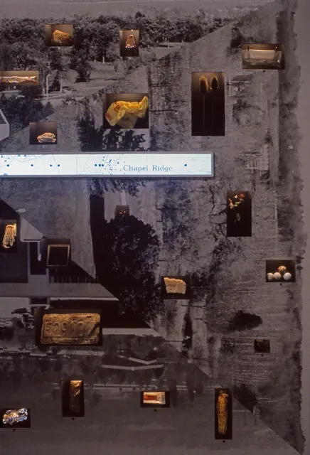 Terra Firma I: Distance Decay: right side of interior wall with illuminated niches and map of east walk