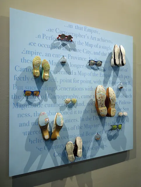 Terra Firma III: panel with text, shoes, glasses, soil domes