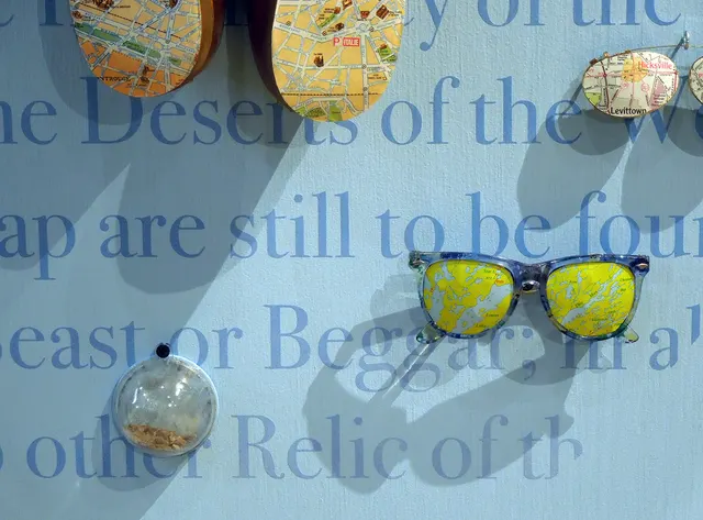 Terra Firma III: panel detail with text, shoes, glasses, soil dome